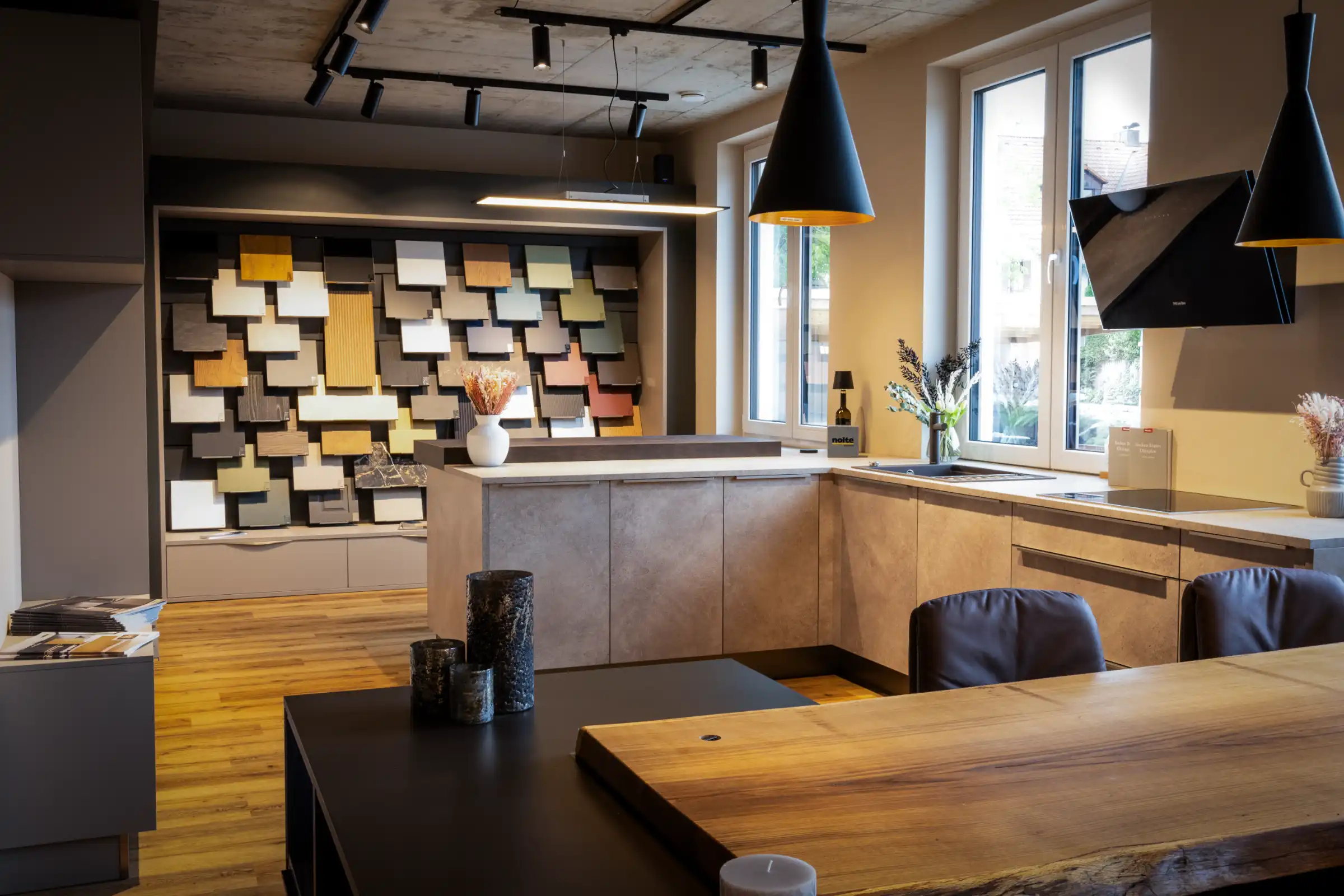 Echtholz Eichenplatte mit Baumkante fungiert als Sitzmöglichkeit und Verbdinung von Küche zu Kochinsel. Kommen SIe vorbei und werfen Sie einen Blick auf umfangreiche Möglichkeiten in der Küchengestaltung bei Thoki - Küche und Weinkonzept