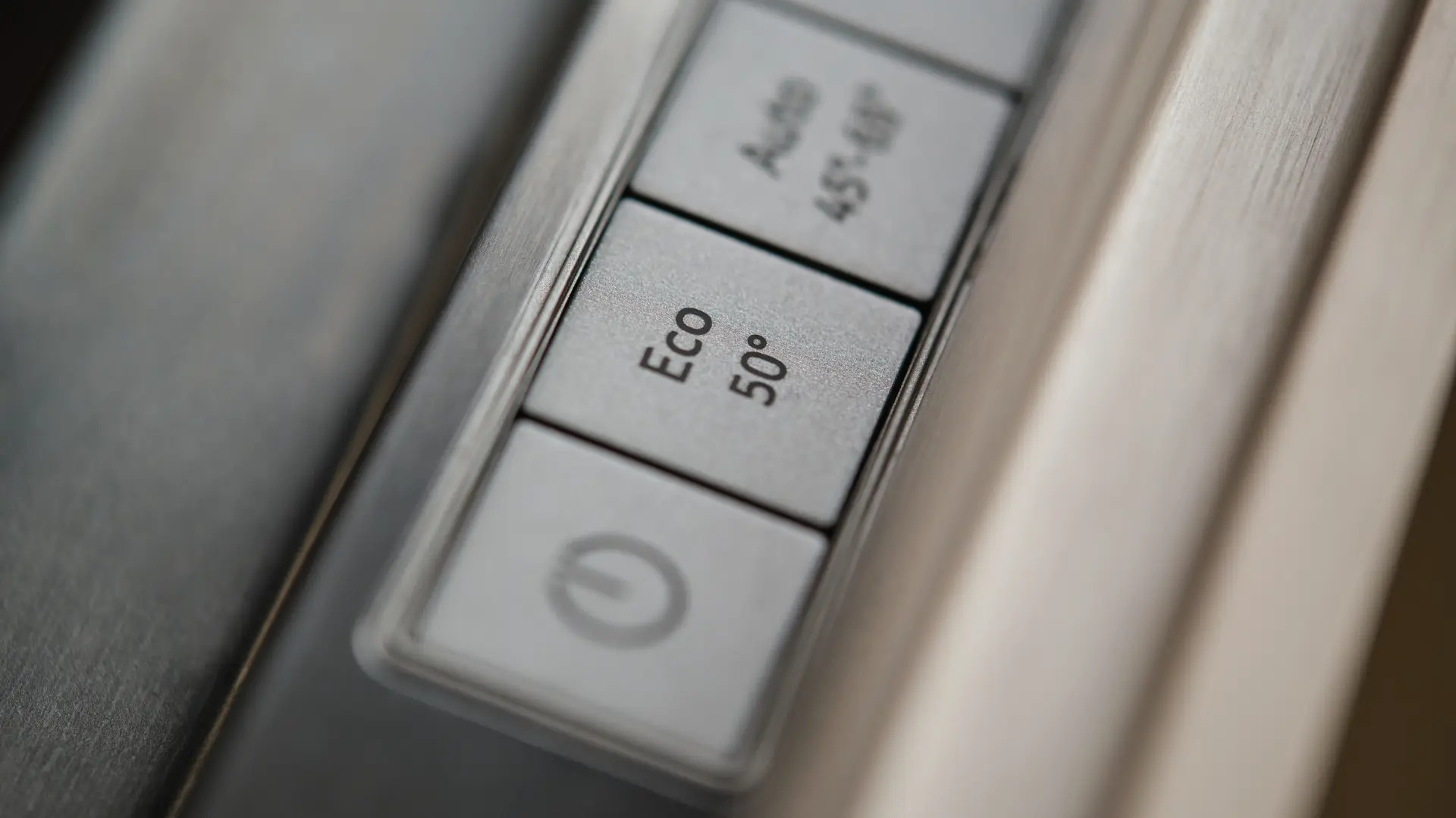 Nahaufnahme der Tasten eines Geschirrspülers, wobei das Eco 50 Grad Programm sichtbar ist.