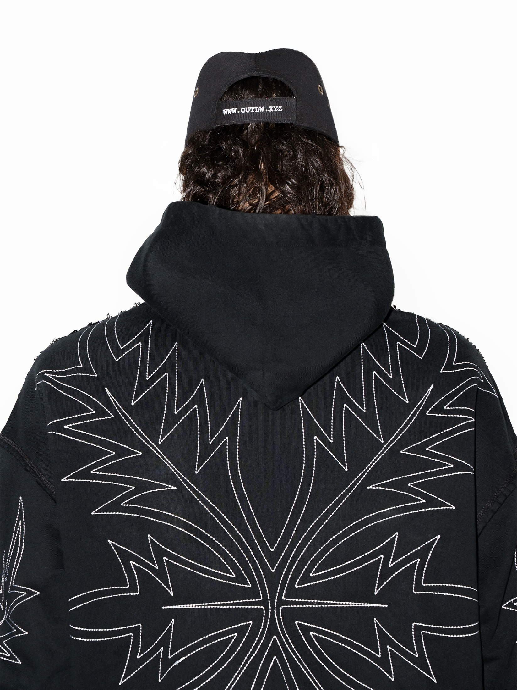 Black streetwear hoodie with embroidered western boot stitch pattern and relaxed fit