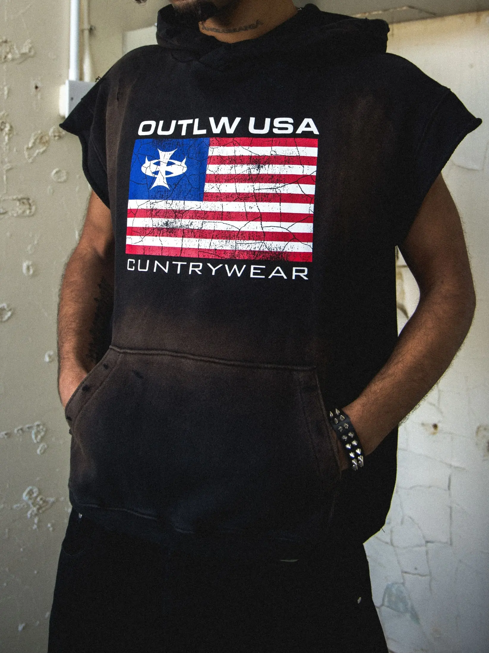 Streetwear photoshoot featuring OUTLW USA clothing on model in urban setting