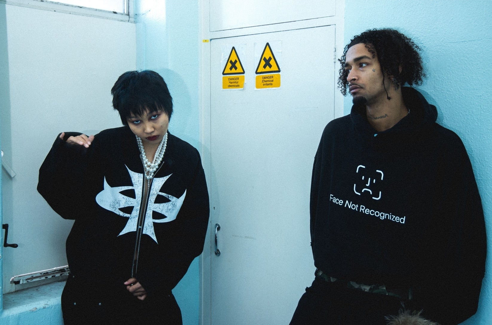 Streetwear photoshoot featuring OUTLW USA clothing on model in urban setting