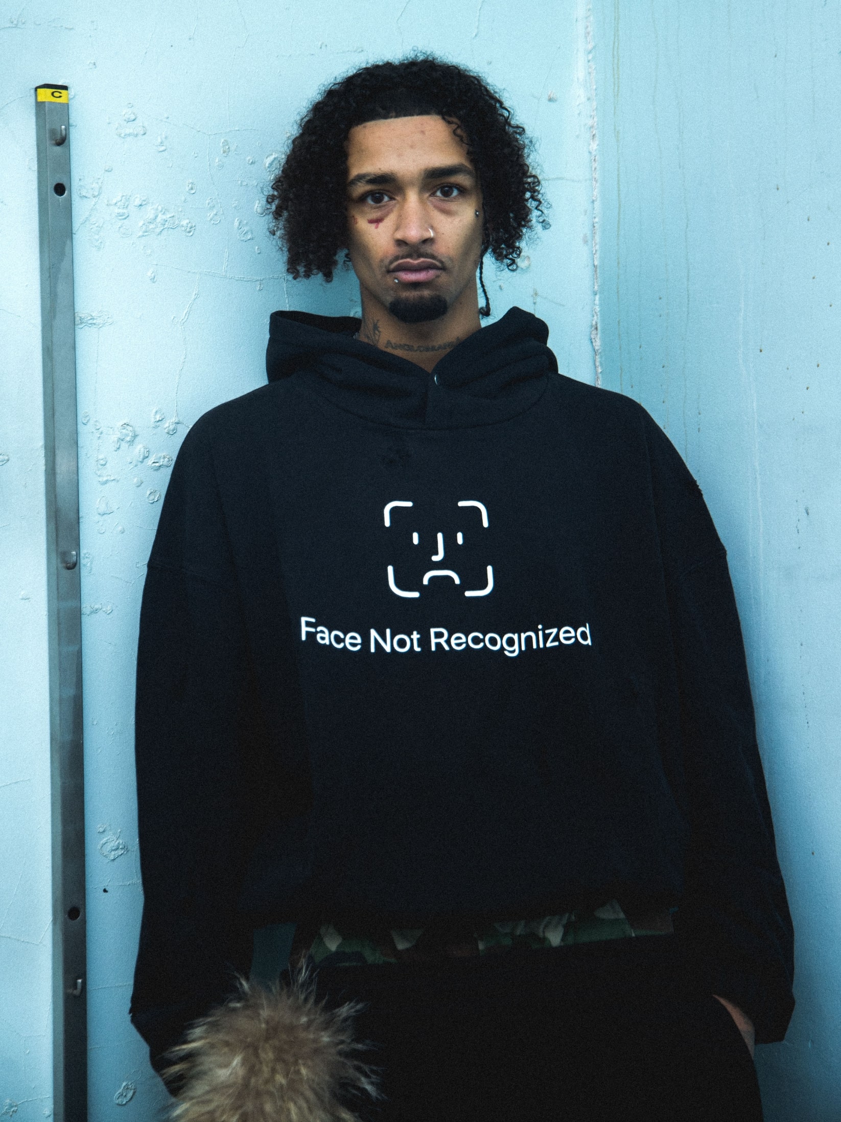 Streetwear photoshoot featuring OUTLW USA clothing on model in urban setting