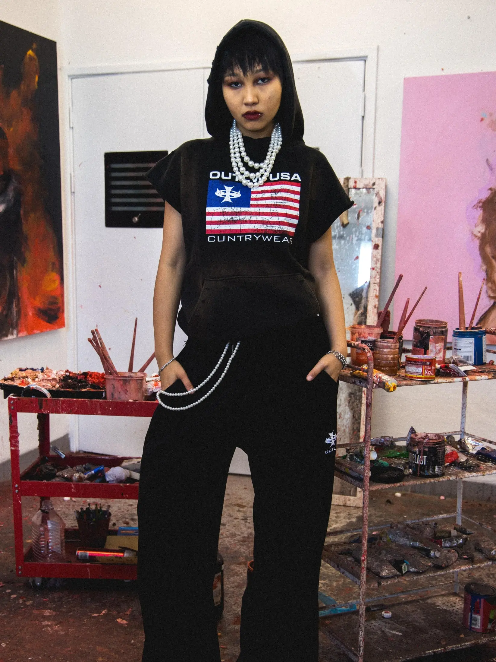 Streetwear photoshoot featuring OUTLW USA clothing on model in urban setting