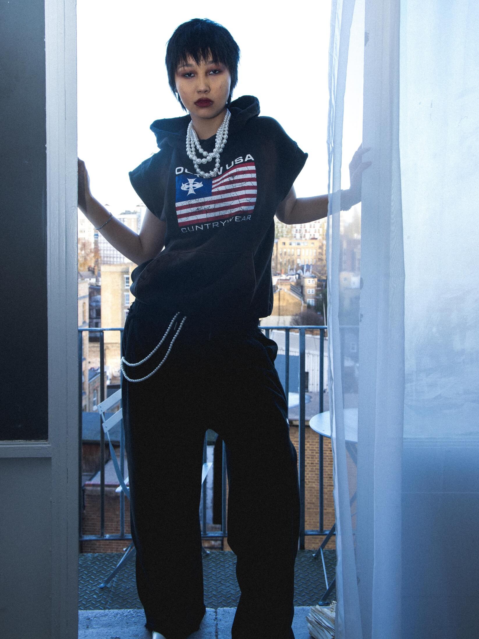 Streetwear photoshoot featuring OUTLW USA clothing on model in urban setting