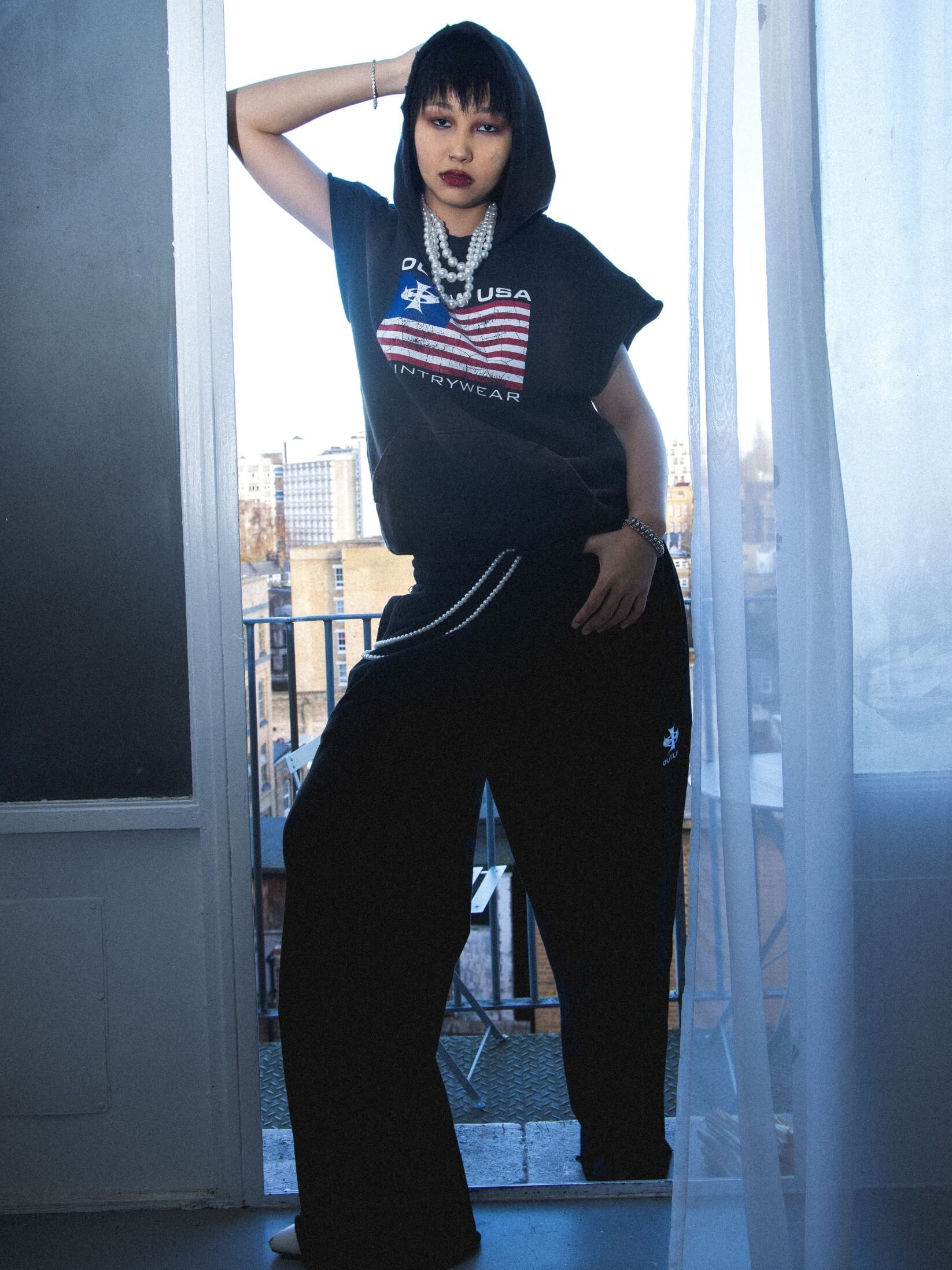 Distressed, sleeveless vintage streetwear hoodie with Outlaw USA flag print