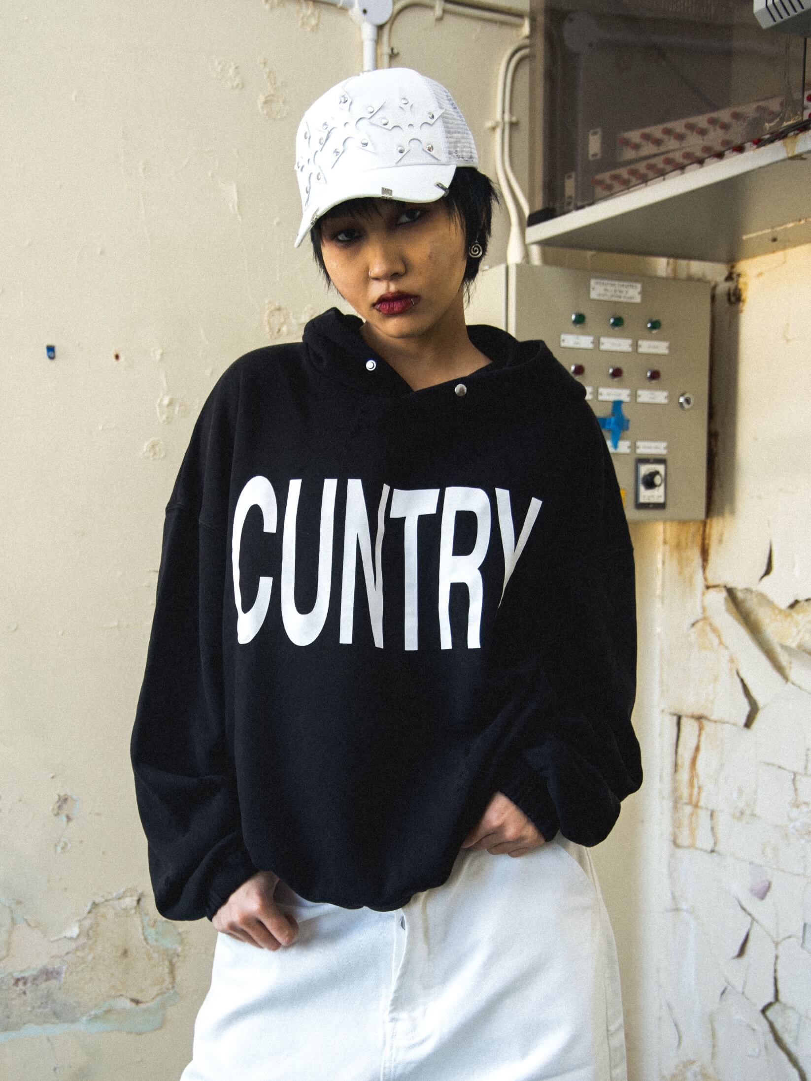 Streetwear photoshoot featuring OUTLW USA clothing on model in urban setting