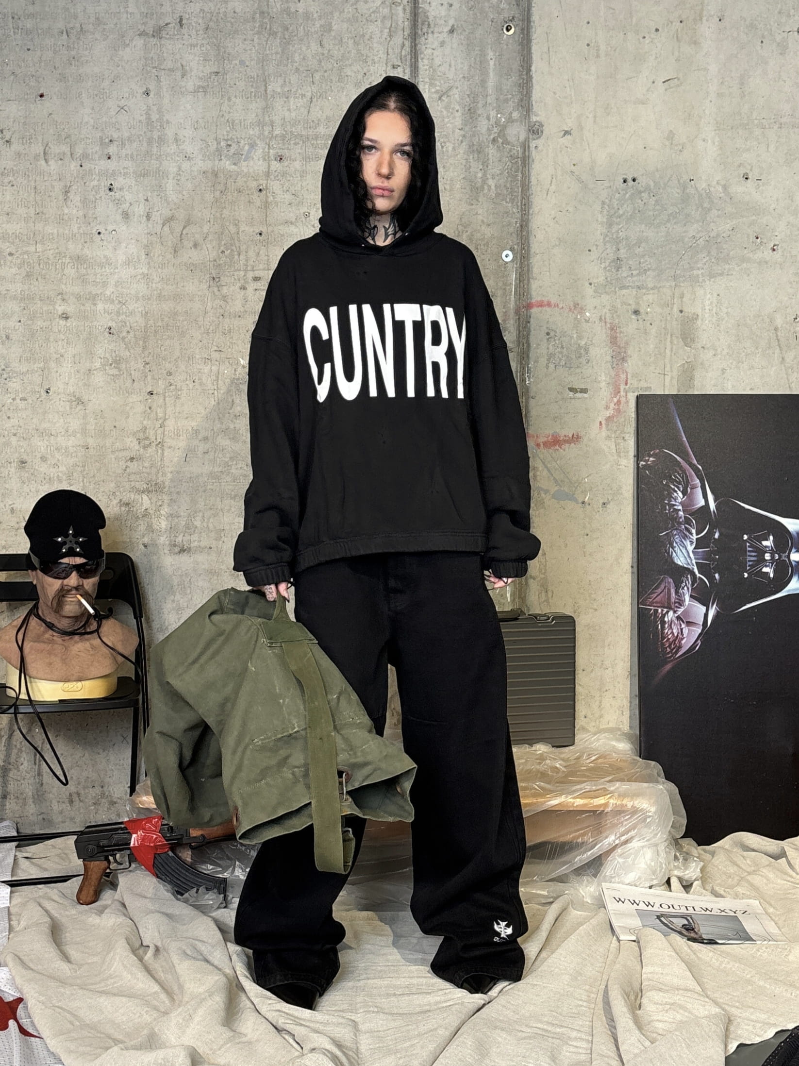 Streetwear photoshoot featuring OUTLW USA clothing on model in urban setting