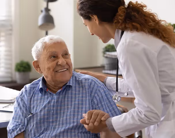 Oxa Care's speech therapist talking with elderly resident