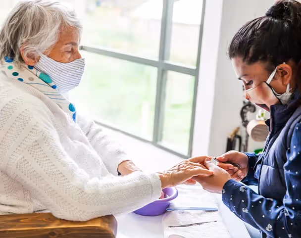 Oxa Care's manicurist working on elderly residents nails