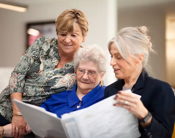 Oxa Care's residential aged care nurses in discussion with elderly resident