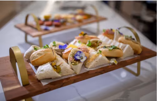 Oxa Care in-house chefs dining platter of wraps and club sandwiches