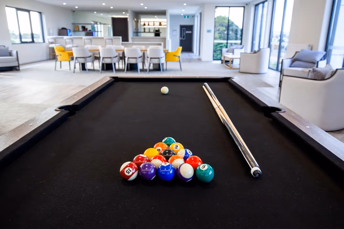 Oxa Care's common area with pool table
