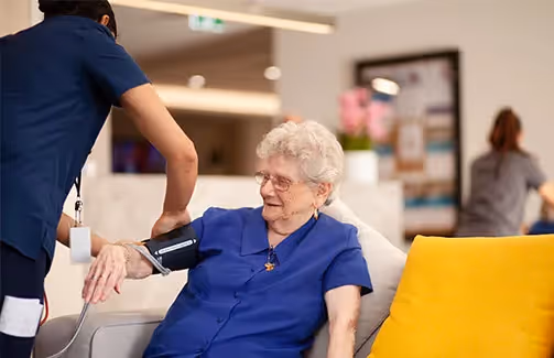 Oxa Care nurse performing a regular health observation on a resident