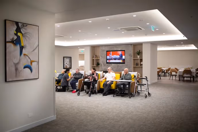 Residents in the cinema room using technology