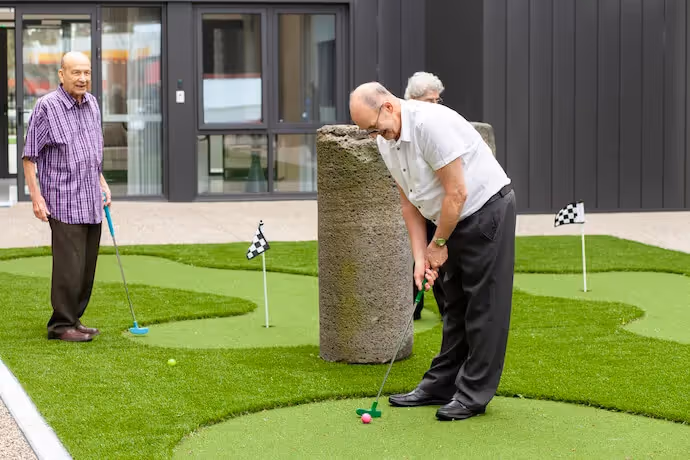 Residents at Oxa playing mini golf