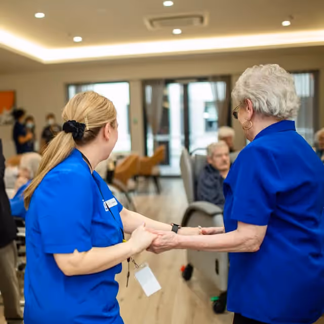 Resident and staff member dancing