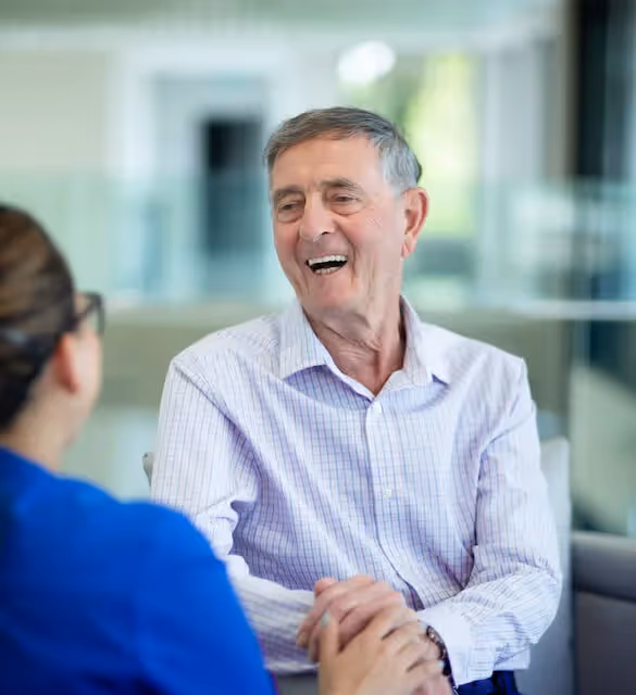 Oxa resident laughing with a member of staff