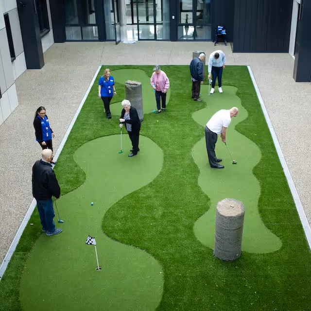 Residents playing mini golf 