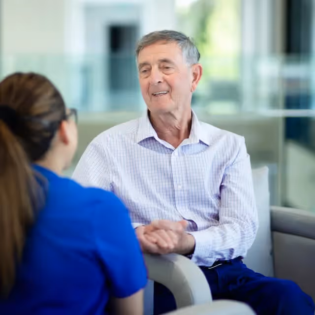 Oxa resident talking to a member of care staff