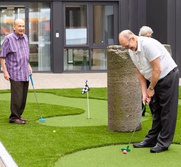 Residents playing mini golf