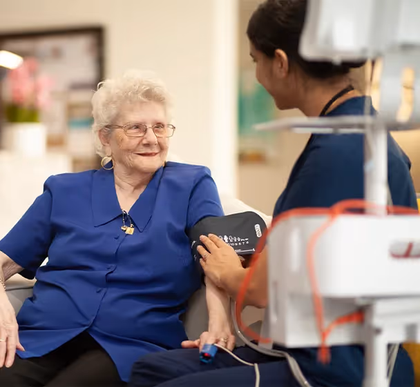Oxa Care staff member providing medical care to a resident