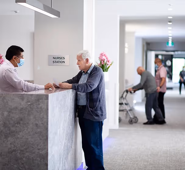 Oxa Care resident in discussion with Oxa Care staff member