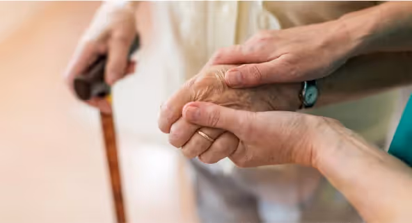 Oxa Care's emergency respite care staff holding hand of resident