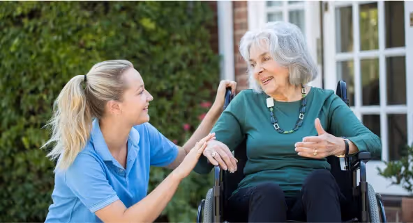 Oxa Care's short-term respite care nurse talking to resident