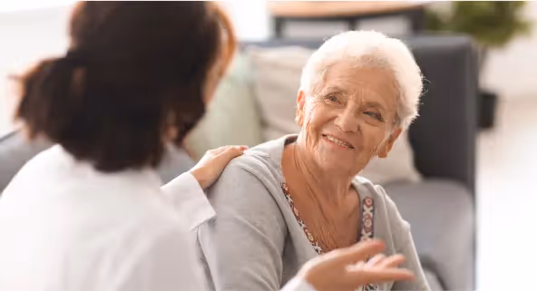 Oxa Care's long-term respite care staff talking to resident