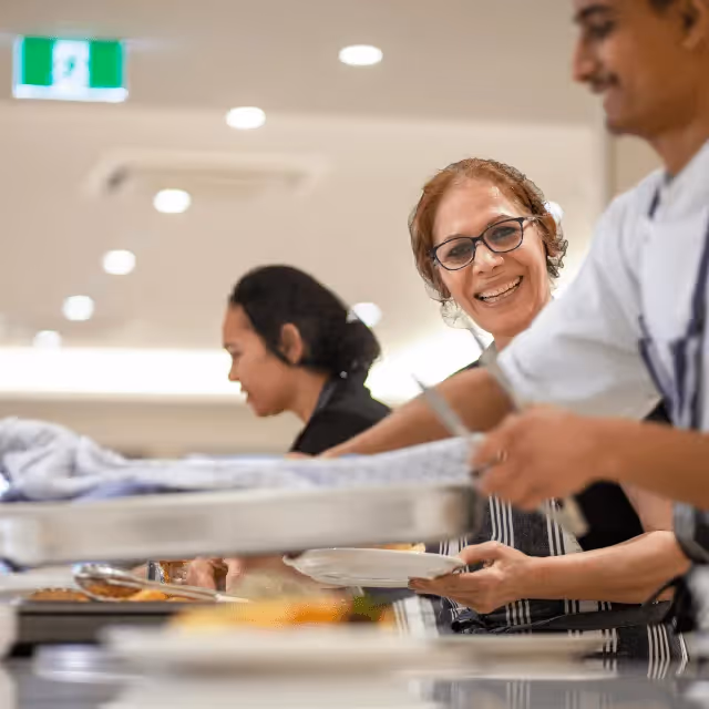 Staff making and serving food