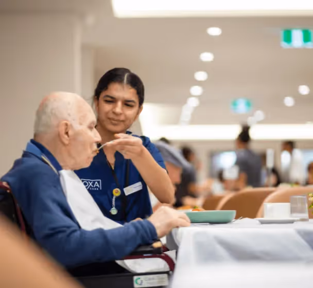 Nurse feeding a resident