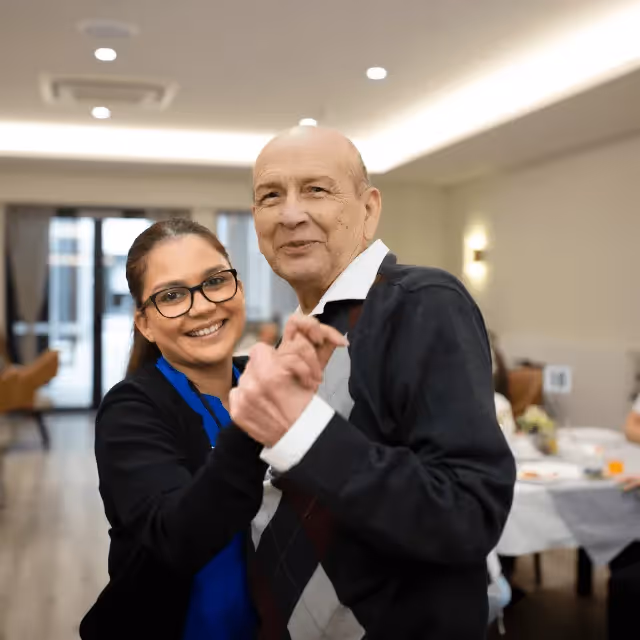 Resident dancing with a nurse 