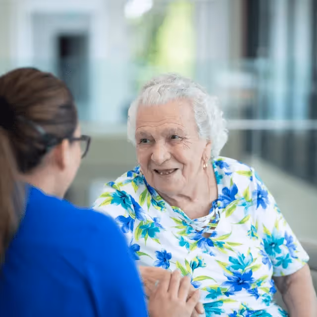 Resident talking with an Oxa Care nurse