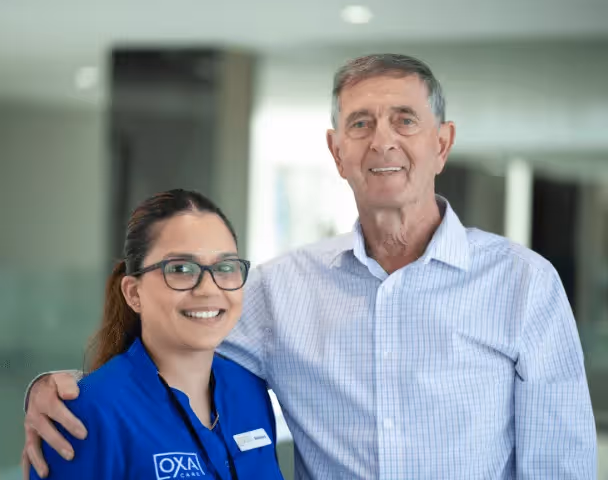 Staff member and resident posing for a photo