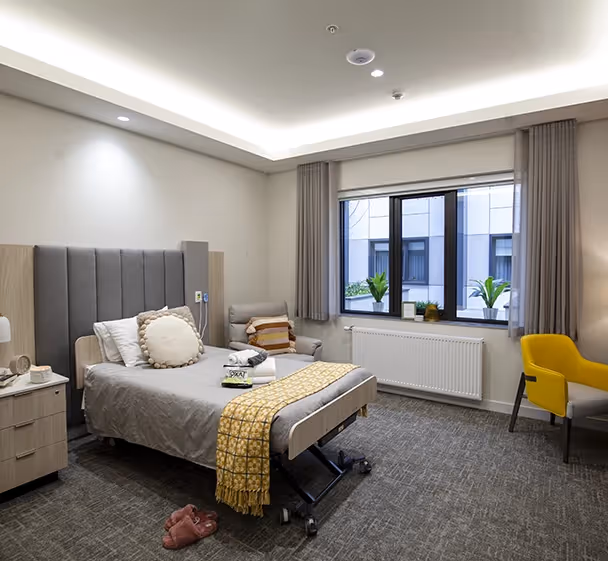 Modern Bundoora aged care accommodation featuring a single suite with private ensuite, soft furnishings, and a welcoming atmosphere.