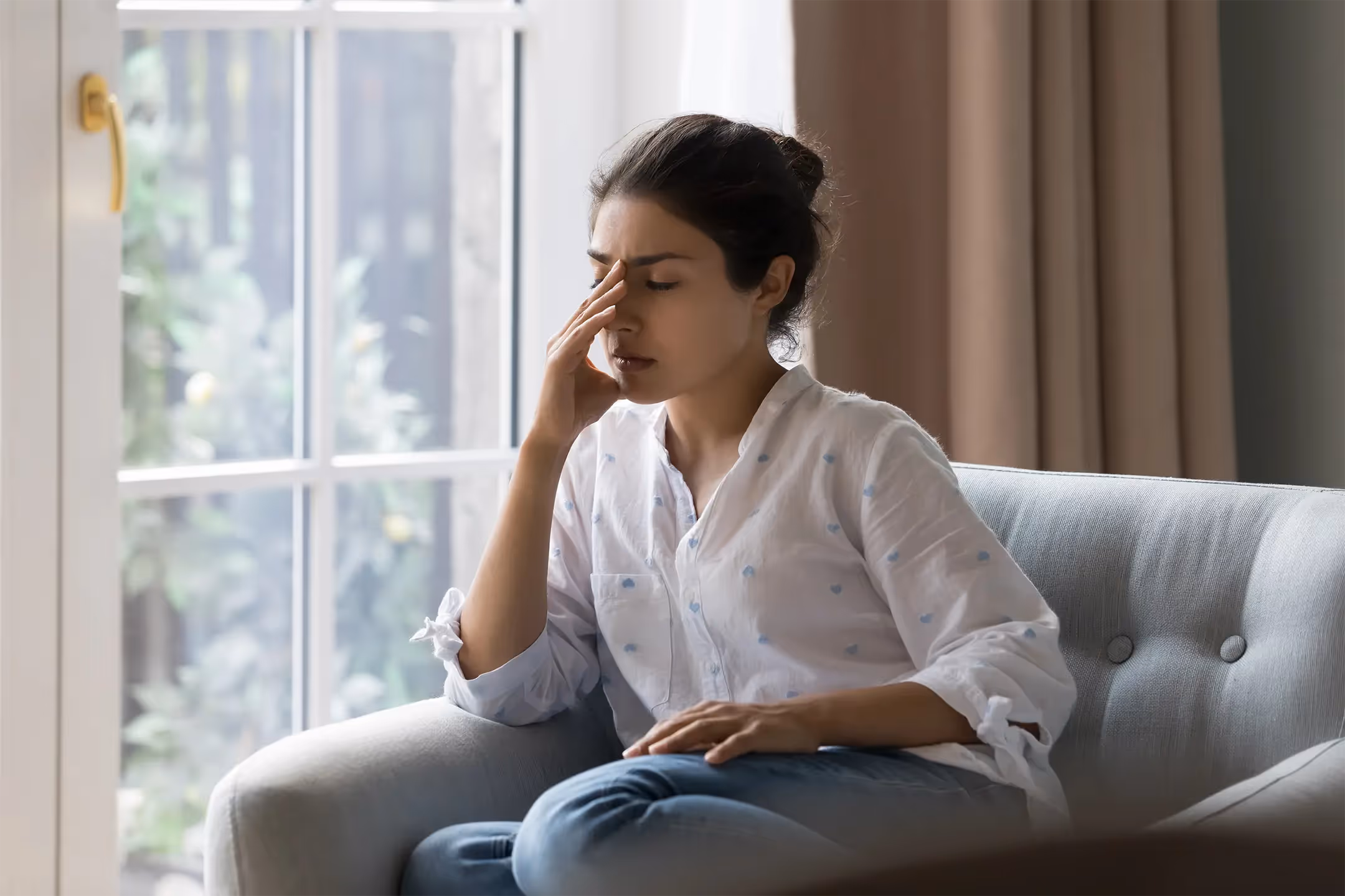 A young carer looking stressed while caring for an elderly person, reflecting the challenges and emotional demands of caregiving.