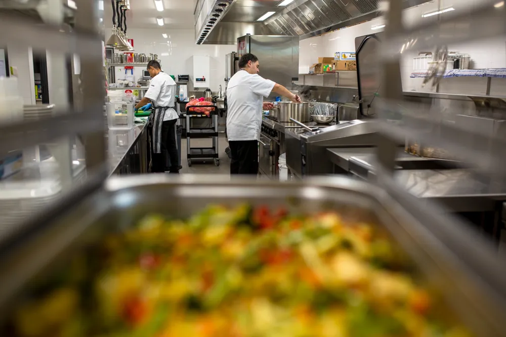 Two chefs working in a professional kitchen at a retirement home.