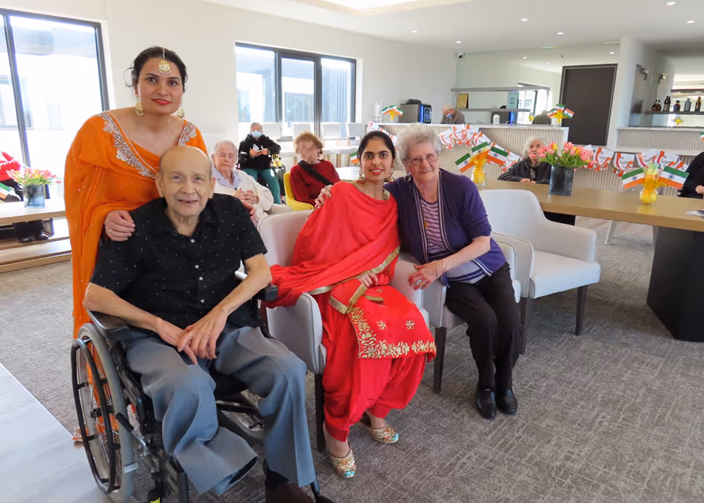 Aged care residents and carers celebrating cultural diversity, with Indian flags and traditional dress displayed throughout the facility.