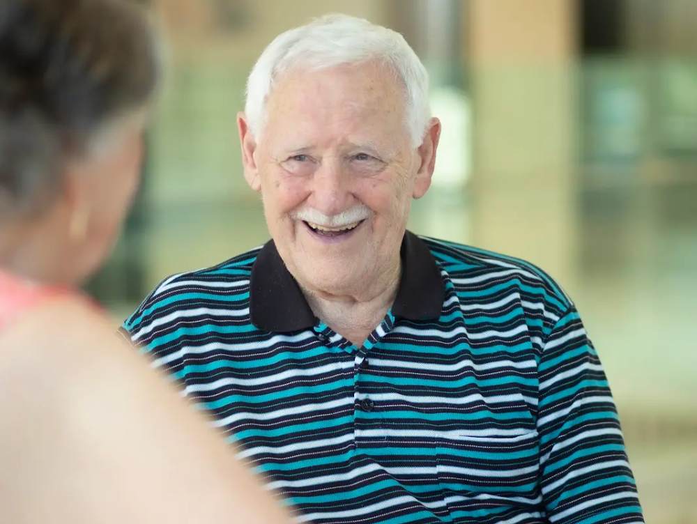 Resident smiling during conversation in a Macedonian-friendly aged care home.