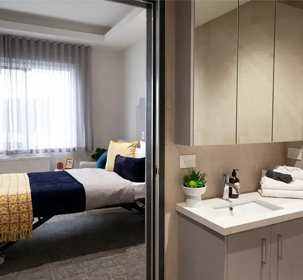 Spacious aged care bedroom with private ensuite bathroom and comfortable furnishings.