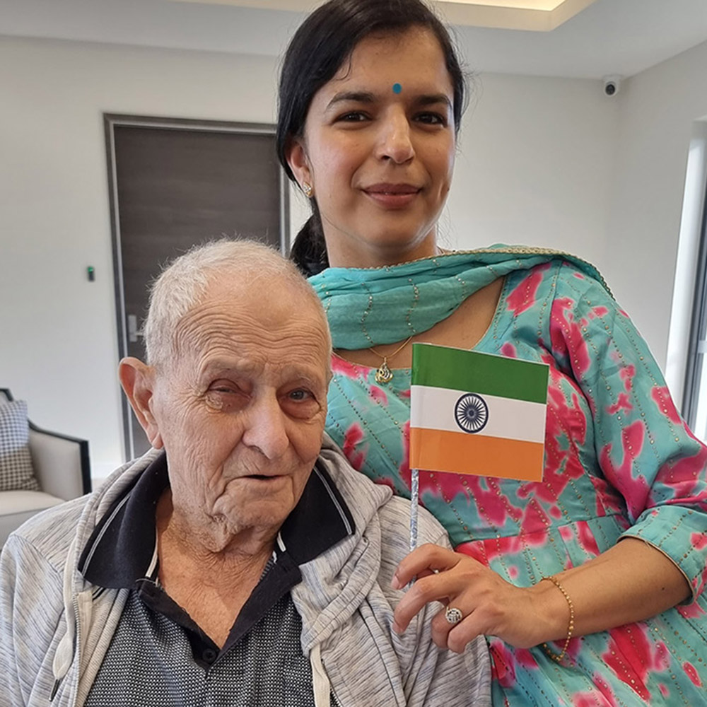 Resident and care team member celebrating cultural diversity at Oxa Care aged care home.