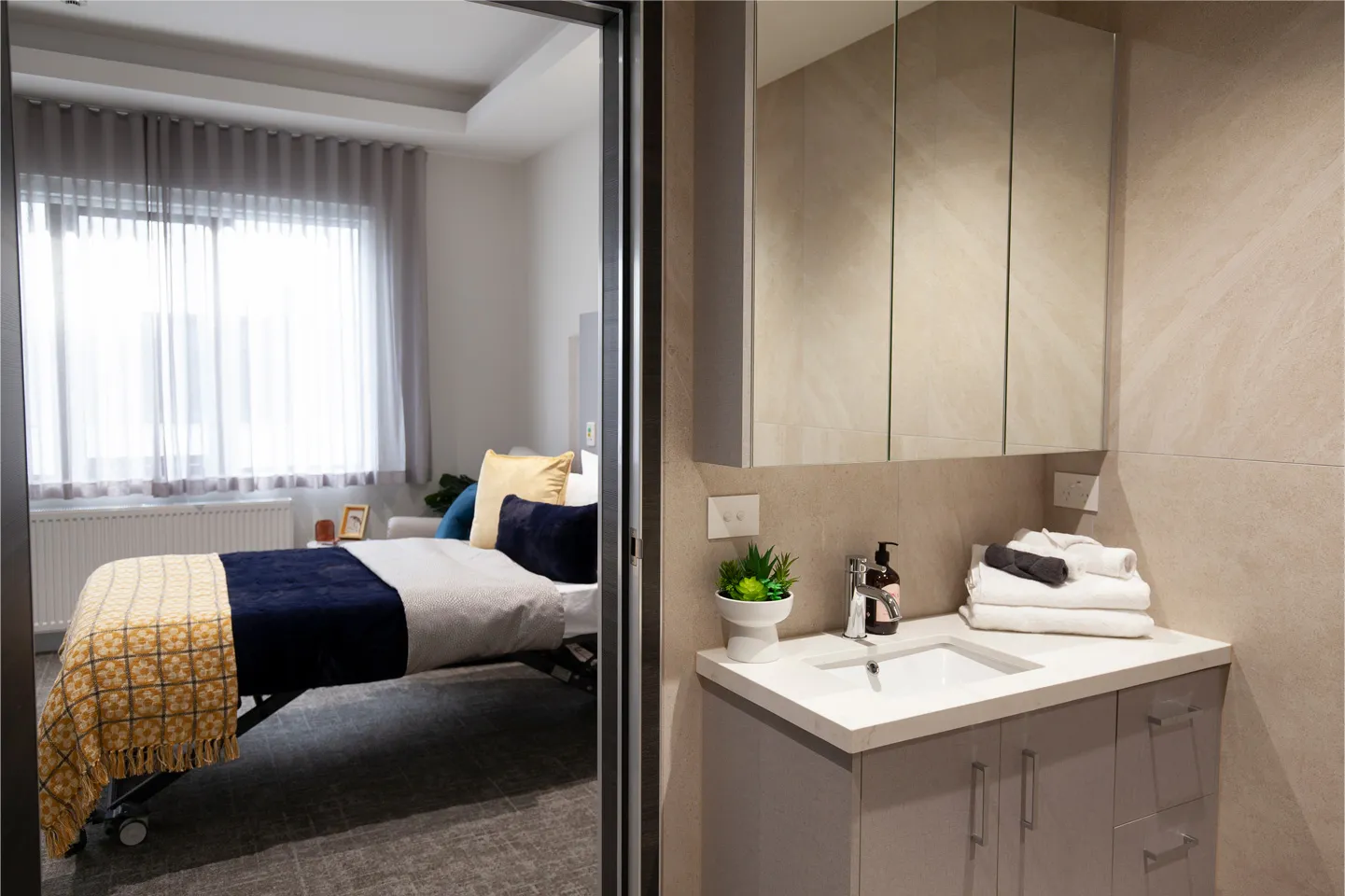 Modern private room with ensuite bathroom designed for comfort, safety and daily care needs.