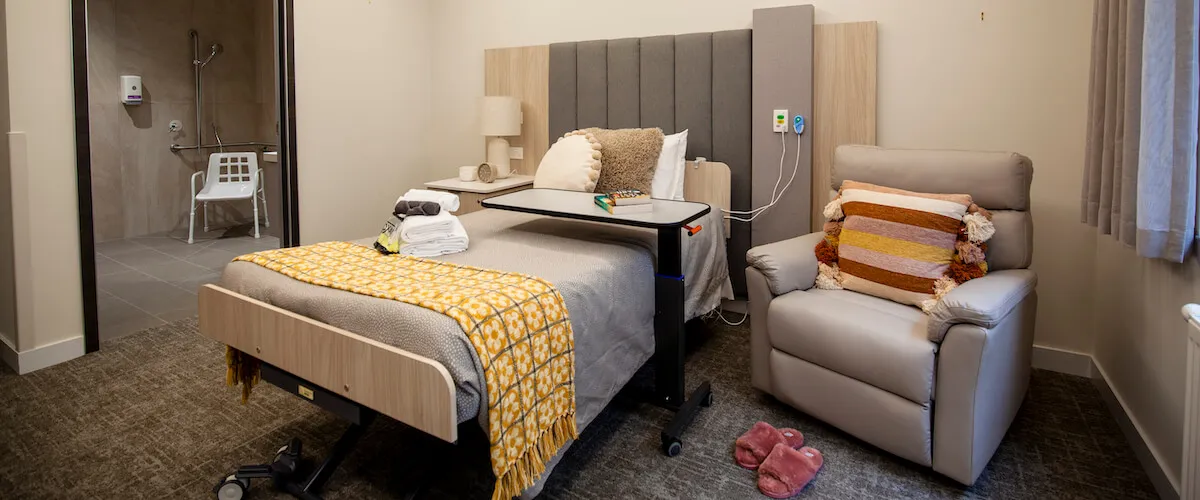 Private resident room with ensuite bathroom, comfortable furnishings and personal touches.