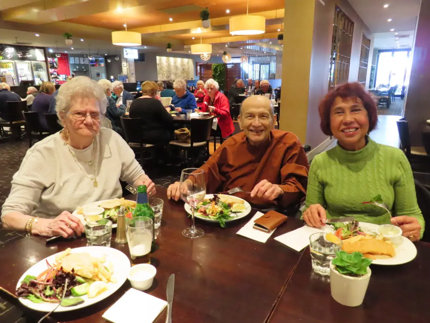 Residents sharing a meal together in a welcoming dining area.