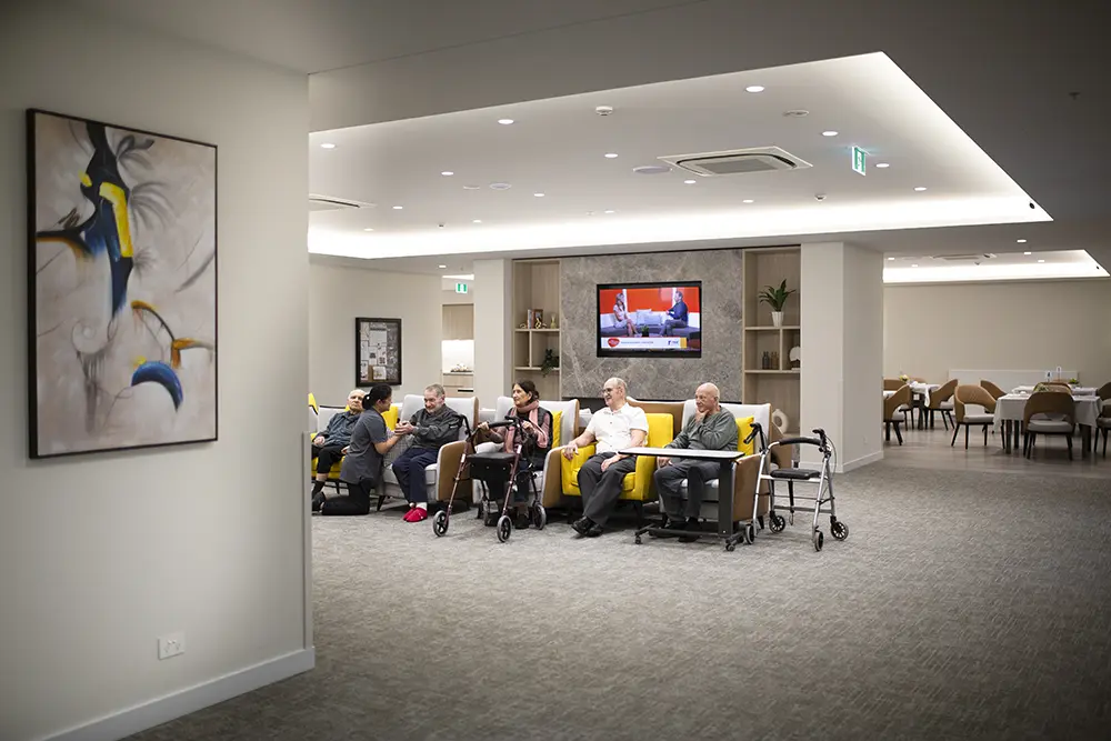 Residents relaxing together in a shared lounge area designed for comfort and connection.