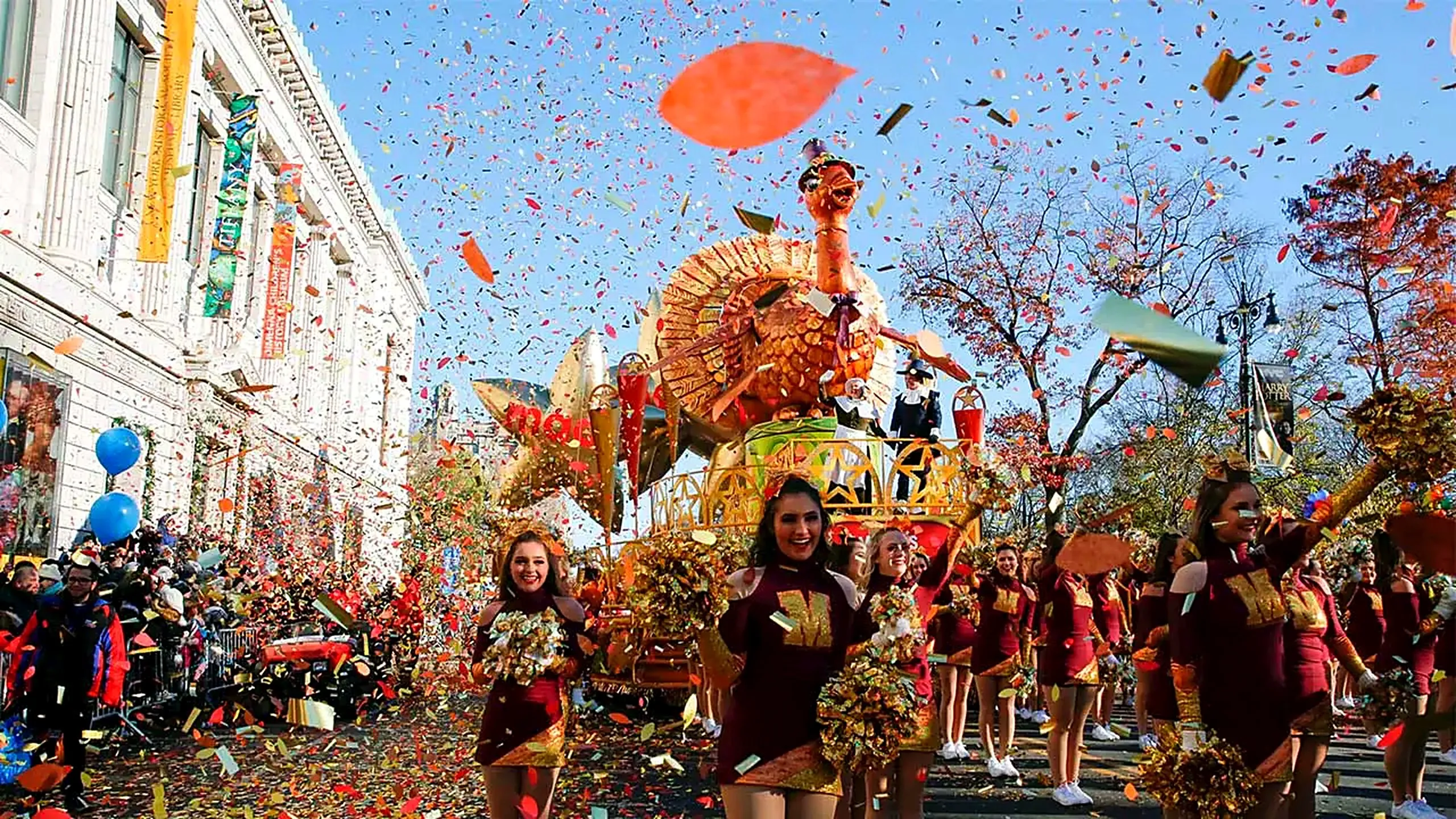 Turkey float and cheerleaders in a confetti shower at the NYC Thanksgiving Day Parade