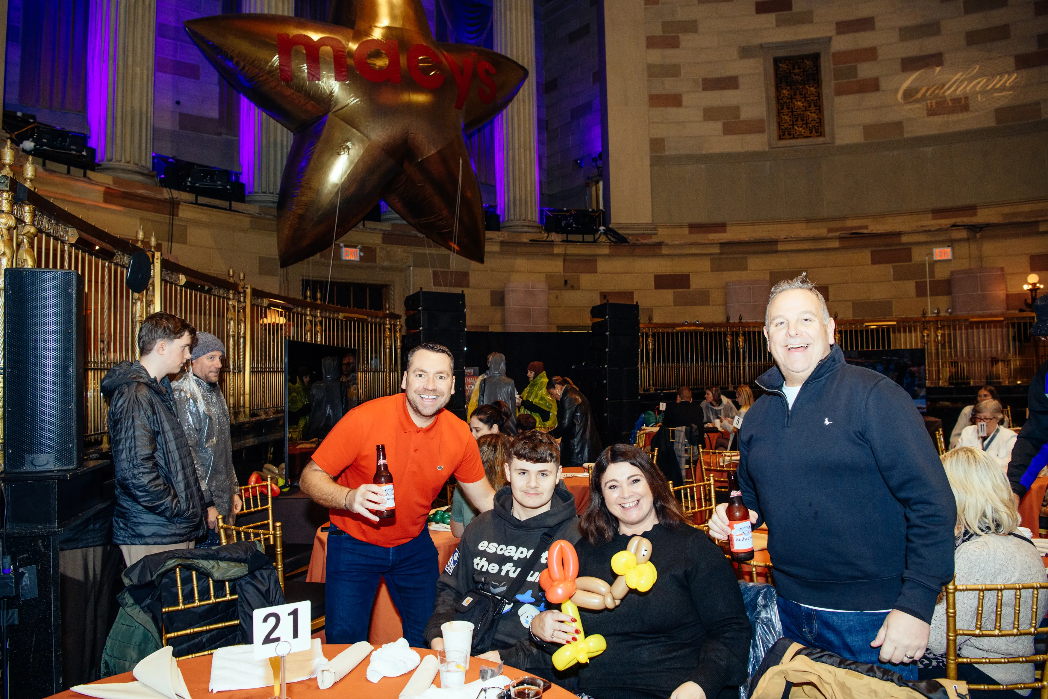 Guests at their table beneath a gold star balloon at Gotham Hall
