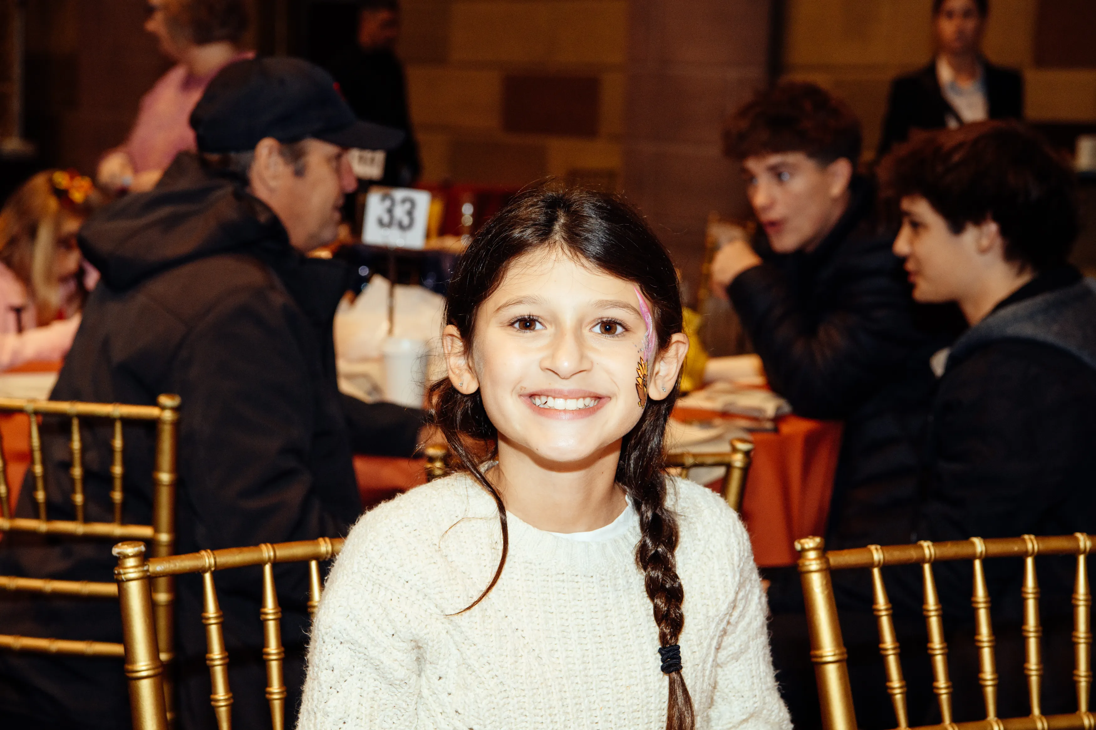A smiling girl at the Thanksgiving parade brunch at Gotham Hall
