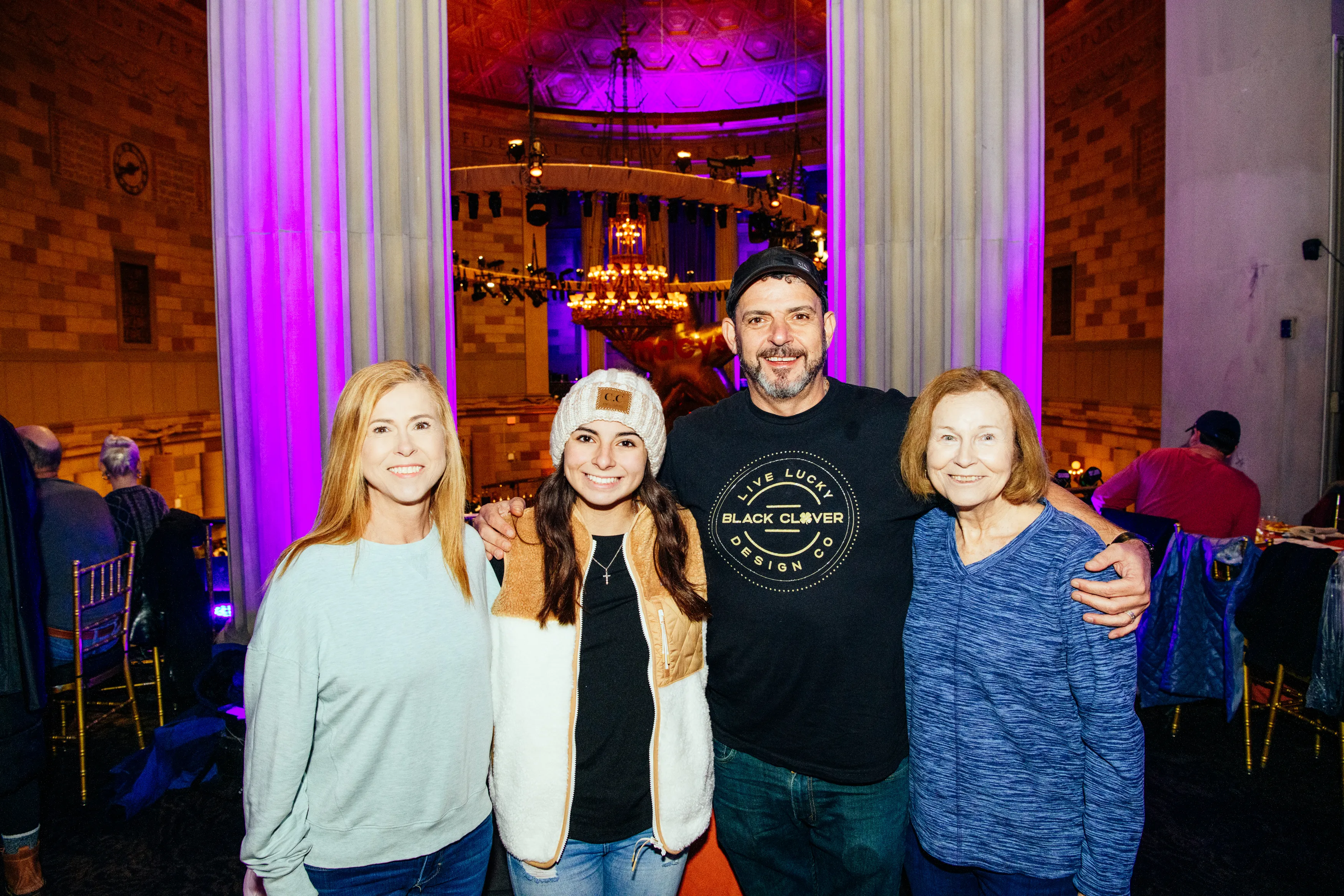 Four guests posing together in the Gotham Hall ballroom on Thanksgiving morning