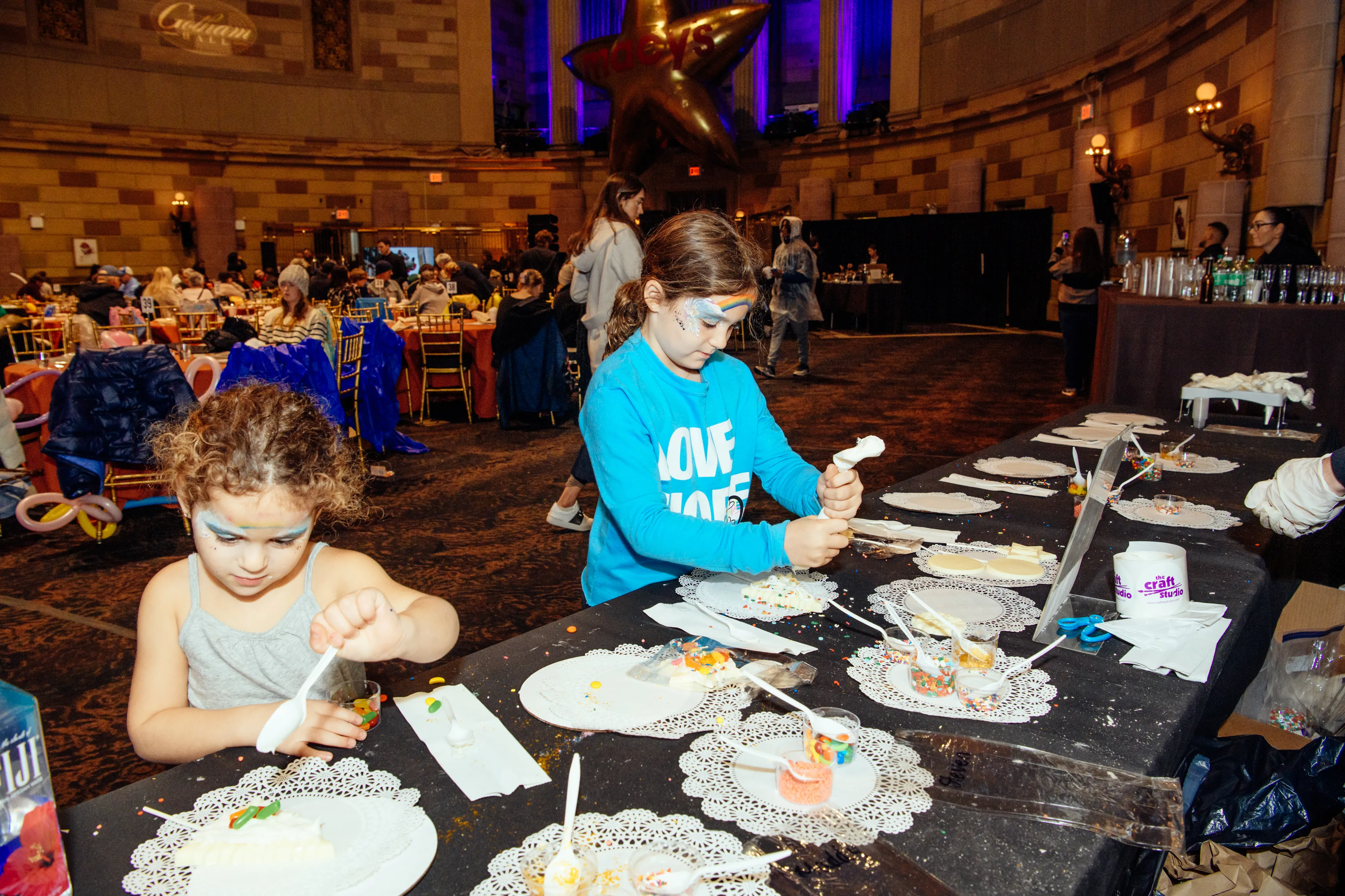 Kids decorating treats at an activity table at Gotham Hall
